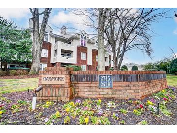 Attractive brick condo building featuring beautiful landscaping and manicured grounds at Oakmore at 2719 Selwyn Ave # 6, Charlotte, NC 28209