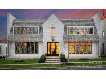 Stunning two-story home with a light brick exterior, complemented by black-framed windows at 2818 Kenwood Sharon Ln, Charlotte, NC 28211