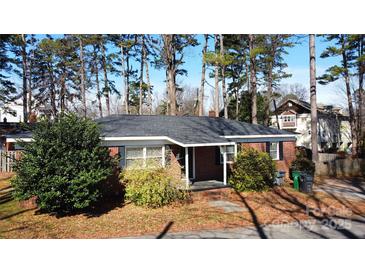 Charming brick ranch-style home with a covered front porch and mature landscaping at 2921 Fort St, Charlotte, NC 28205
