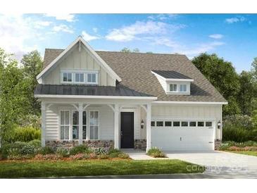 Charming two-story home with stone accents, a covered front porch, and a two-car garage at 305 Basil Dr, Indian Trail, NC 28079