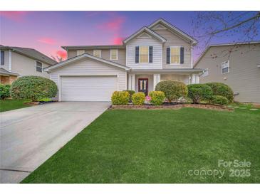 Charming two-story home featuring a well-manicured lawn, beautiful landscaping, and a classic design with a red front door at 433 Annaberg Ln, Monroe, NC 28110