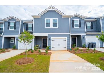 Charming townhome featuring a one car garage, neutral exterior, and neatly maintained lawn at 508 Tayberry Ln, Fort Mill, SC 29715