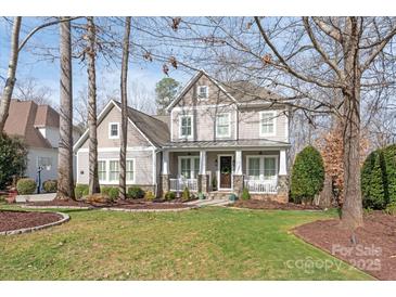 Charming two-story home featuring a welcoming front porch, manicured lawn, and classic architectural details at 618 Bannerman Ln, Fort Mill, SC 29715