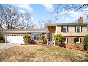 Charming home with a well-maintained lawn, brick facade, and a spacious two-car garage at 7300 Falkirk Pl, Charlotte, NC 28270