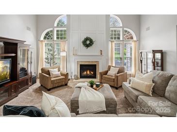 Bright living room features high ceilings, a fireplace, and a cozy seating area with natural light at 809 Circle Trace Rd, Monroe, NC 28110