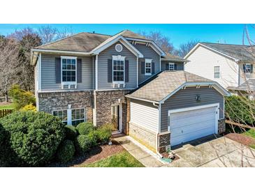 Charming two-story home featuring brick accents, gray siding and an attached two-car garage at 10436 Cullen Ct, Charlotte, NC 28278