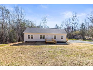 Charming single story home with light siding and new deck in a serene wooded setting at 1173 Yorkdale Ln, Lincolnton, NC 28092