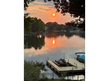 Scenic lake view at sunset, reflecting the warm glow of the setting sun at 17701 Springwinds Dr, Cornelius, NC 28031
