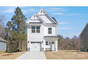 Charming two-story home with a white exterior, a welcoming entryway, and a convenient attached garage at 2125 Tom Sadler Rd # 7159, Charlotte, NC 28214