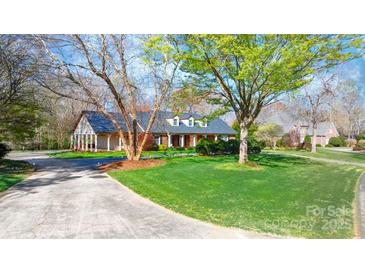 Beautiful brick home with manicured lawn, mature trees and circular drive at 4025 4Th Street Nw Ln, Hickory, NC 28601