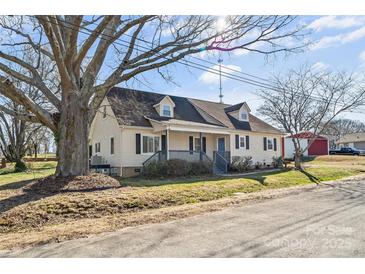 Charming two-story home with a covered front porch and mature trees at 406 E 29Th St, Kannapolis, NC 28083