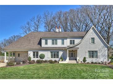 Beautiful two-story home with landscaped yard, manicured lawn, and classic white painted brick at 4117 Tyng Way, Charlotte, NC 28211