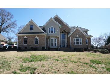 Charming brick home featuring a symmetrical design, arched windows, and well-manicured lawn under a clear blue sky at 4531 Landmark Dr, Rock Hill, SC 29732