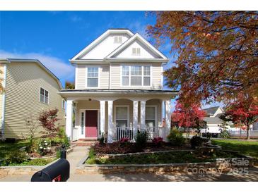 Charming two-story home with a welcoming front porch and beautifully landscaped front yard at 12123 Monteith Grove Dr, Huntersville, NC 28078