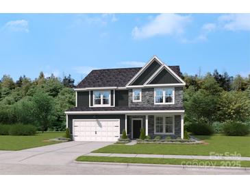Charming two-story home with stone accents, a two-car garage, and a manicured lawn at 318 Balboa St, Matthews, NC 28104