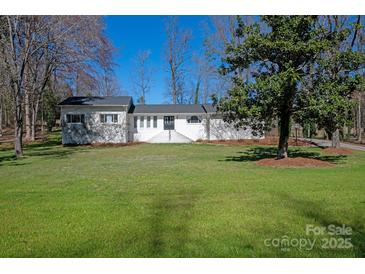 Charming single-story home featuring a lush green lawn and a welcoming front entrance at 534 Kirby Ln, Matthews, NC 28104