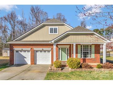 Charming brick home with a two-car garage, manicured lawn and attractive curb appeal at 571 Rough Hewn Ln, Rock Hill, SC 29730