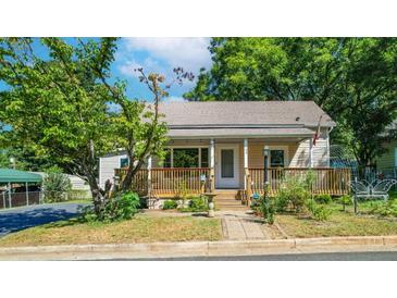 Charming single-story home with a cozy, covered front porch and mature trees at 108 Jackson St, Fort Mill, SC 29715