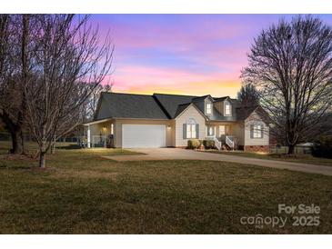 Charming single-Gathering home with a two-car garage, well-maintained lawn and cozy curb appeal at sunset at 111 Lynnette Dr, Mt Ulla, NC 28125