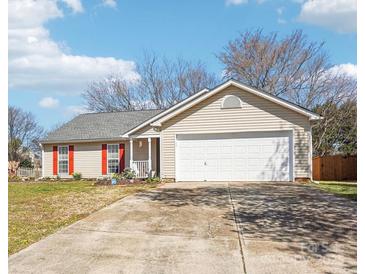 Charming single-story home featuring a two-car garage, red shutters, and a well-manicured front yard at 14429 Planters Knob Ln, Charlotte, NC 28273