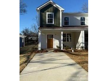 Charming two-story home with a welcoming porch and well-manicured lawn at 1520 Norris Ave, Charlotte, NC 28206