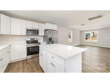 Modern kitchen with white cabinets, stainless steel appliances, and a center island at 2206 Hillcrest Ave, Albemarle, NC 28001