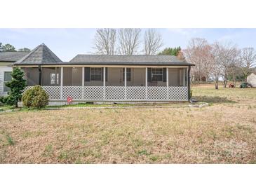 Quaint home featuring a cozy screened front porch with white lattice details at 3966 Peach St # 56, Newton, NC 28658