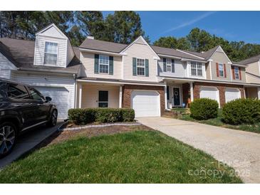 Charming townhome featuring a well-manicured lawn, attached garage and lovely curb appeal at 4586 Antelope Ln, Charlotte, NC 28269