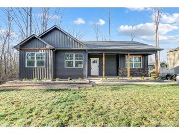 Charming one-story home featuring a covered front porch and manicured lawn at 7595 Lakehaven Dr, Denver, NC 28037