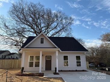 Charming single-story home boasts a welcoming front porch and neutral siding at 803 Fargo Dr, Concord, NC 28027