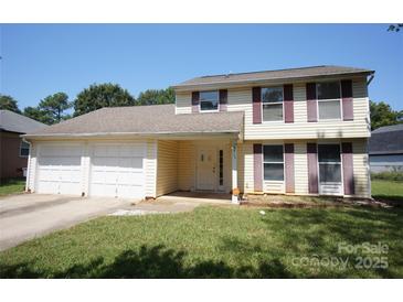 Charming two-story home with a two-car garage and well-maintained lawn at 8915 Touchstone Ln, Charlotte, NC 28227