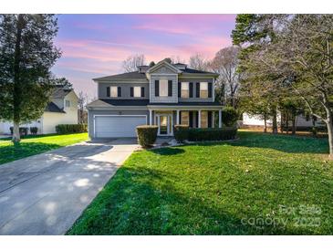 Charming two-story home with manicured lawn and inviting entrance, complemented by a spacious driveway at 110 Hazelton Loop, Mooresville, NC 28117