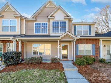 Charming townhome with landscaped front yard, brick accents, and a welcoming entryway at 13510 Tranters Creek Ln, Charlotte, NC 28273