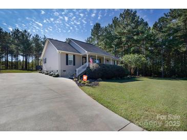 Charming single-story home featuring a well-manicured lawn, beautiful landscaping, and a welcoming front porch at 1661 California Rd, York, SC 29745