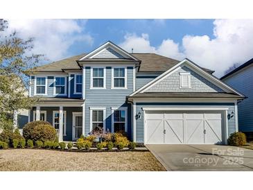 Charming two-story home with blue siding, white trim, and a well-manicured front yard at 2056 Angel Oak Dr, Fort Mill, SC 29715