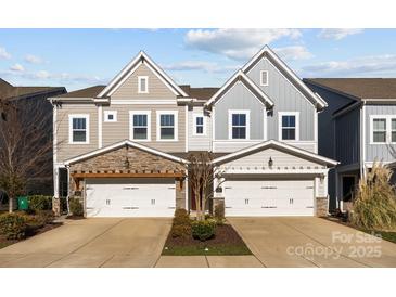 Charming townhome with neutral siding, stone accents, attached garages, and well-manicured landscaping at 343 Belton St, Charlotte, NC 28209