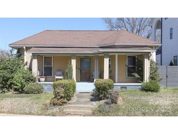 Charming single-story home with a welcoming front porch and well-maintained landscaping at 1001 Parkwood Ave, Charlotte, NC 28205