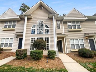 Charming townhome with large windows, neutral siding, and well-maintained landscaping at 1269 E Woodlawn Rd, Charlotte, NC 28209