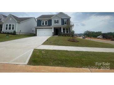Two-story home with a manicured lawn, a concrete driveway and a two-car garage at 136 Glenn Dr, Mooresville, NC 28115