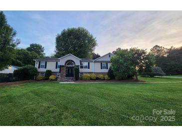 Charming two-story home featuring well-manicured lawn, and decorative stone accents at 2200 Peninsula Ave, Shelby, NC 28150