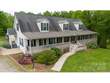 Inviting two-story home featuring a spacious front porch and manicured lawn at 3199 Harmony Rd, Catawba, SC 29704