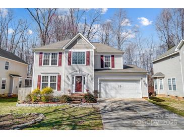 Charming two-story home with white siding, red shutters, and a well-maintained front yard at 4427 Brandie Glen Rd, Charlotte, NC 28269