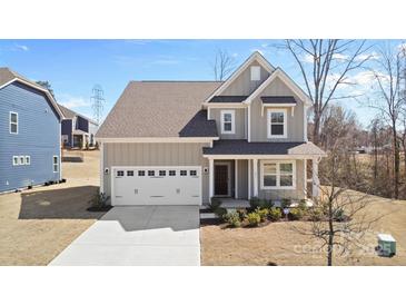 Charming two-story home with a two-car garage and a well-manicured front yard at 491 Creevy Nw Dr, Concord, NC 28027