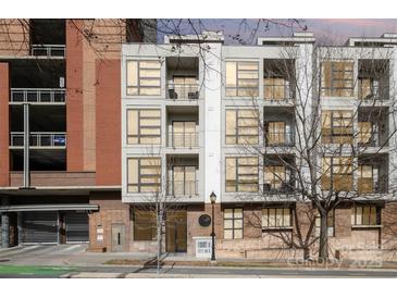 Modern condo building with large windows and balconies, offering city views and contemporary design at 525 E Sixth St # 208, Charlotte, NC 28202