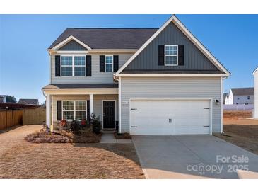 Charming two-story home with gray siding, black shutters, and a two-car garage at 6015 Ahoskie Dr, Charlotte, NC 28215