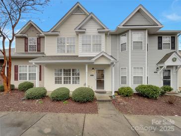 Charming multi-tone townhouse with manicured landscaping, sidewalk and inviting front door at 725 Rock Lake Gln, Fort Mill, SC 29715