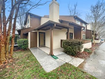 Inviting two-story home featuring a covered porch and a mix of siding and stucco exterior at 7340 Winery Ln, Charlotte, NC 28227