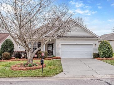 Charming single Gathering home featuring a manicured lawn and an attached two car garage at 841 Platinum Dr, Fort Mill, SC 29708