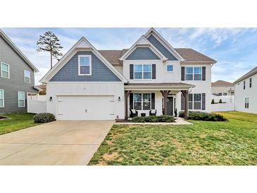 Charming two-story home with white siding, blue accents, a well-maintained lawn, and an attached two-car garage at 2408 Napa Ter, Clover, SC 29710