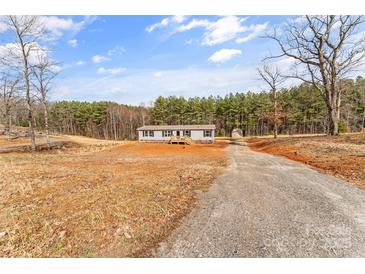 Quaint single-story home with a gravel driveway, offering a serene country living experience and lots of land at 255 Liberty Estates Ln, Taylorsville, NC 28681